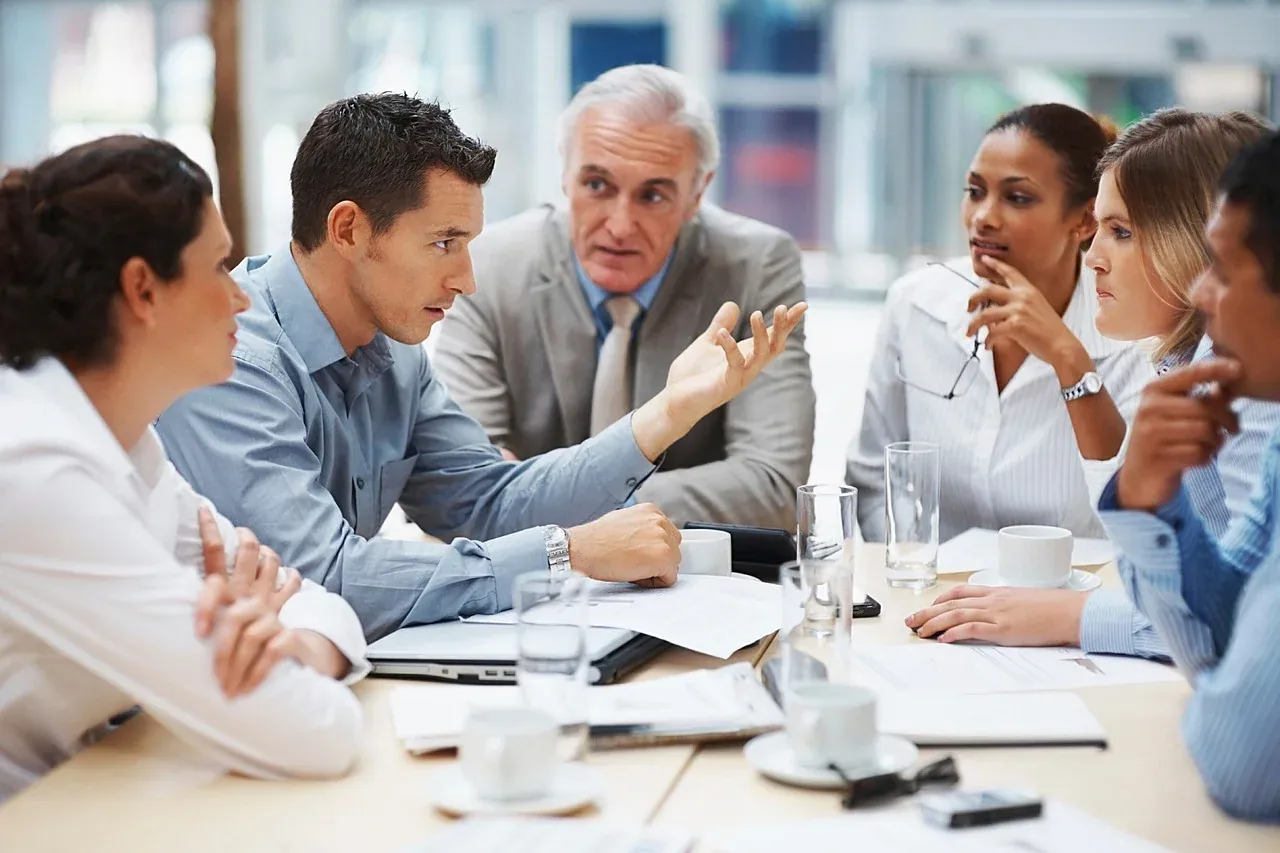 People discussing work around a table
