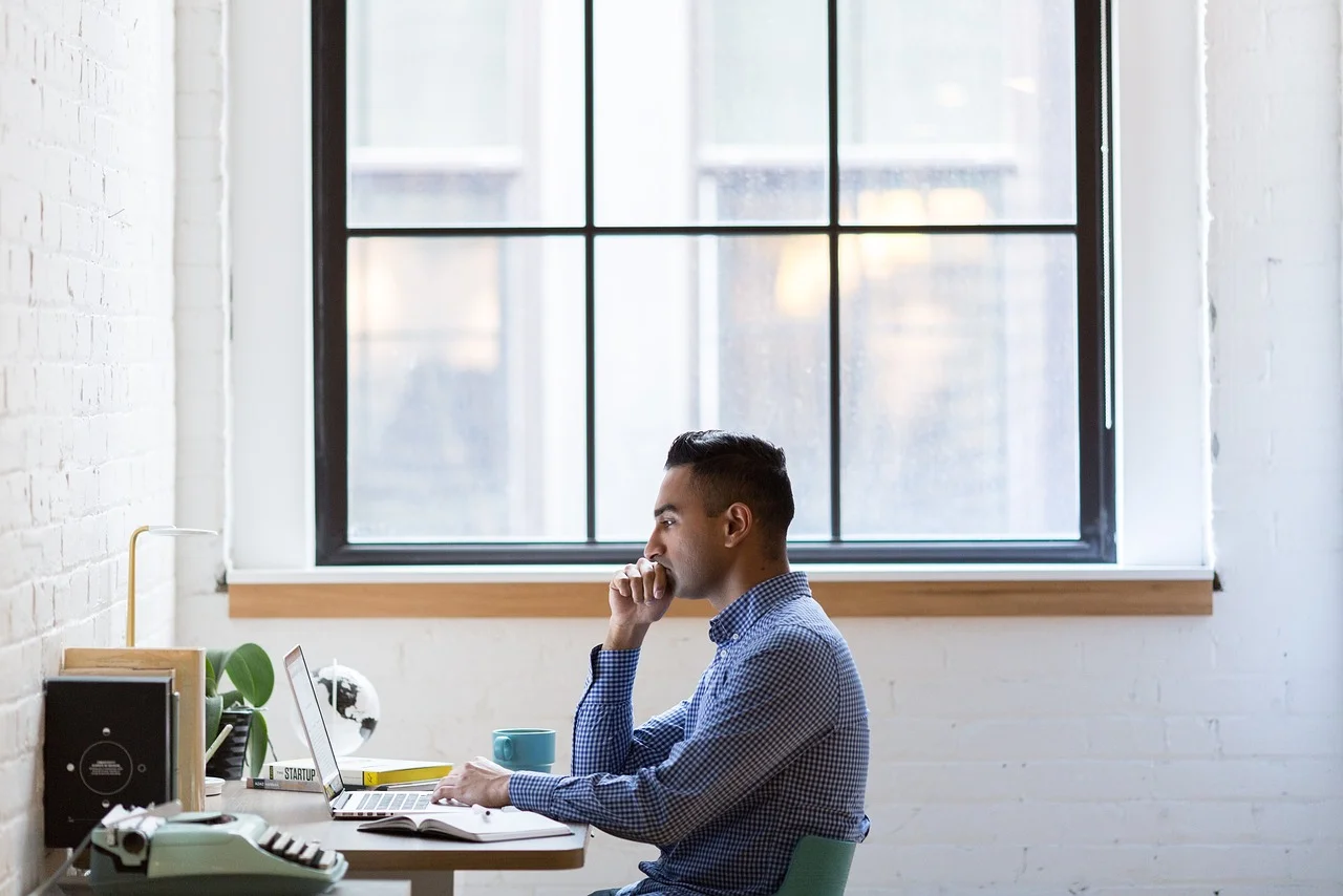A person working at a laptop in an office