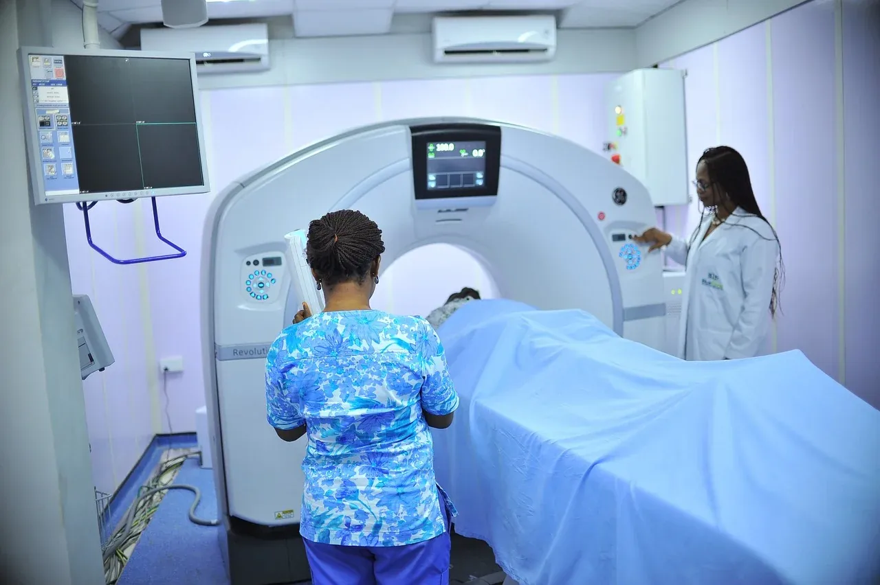 A healthcare worker preparing medical imaging equipment